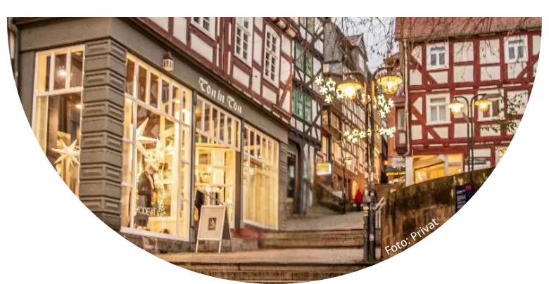 Gasse mit Treppe; seitlich Fachwerkhäuser und Weihnachtsbeleuchtung in Marburg